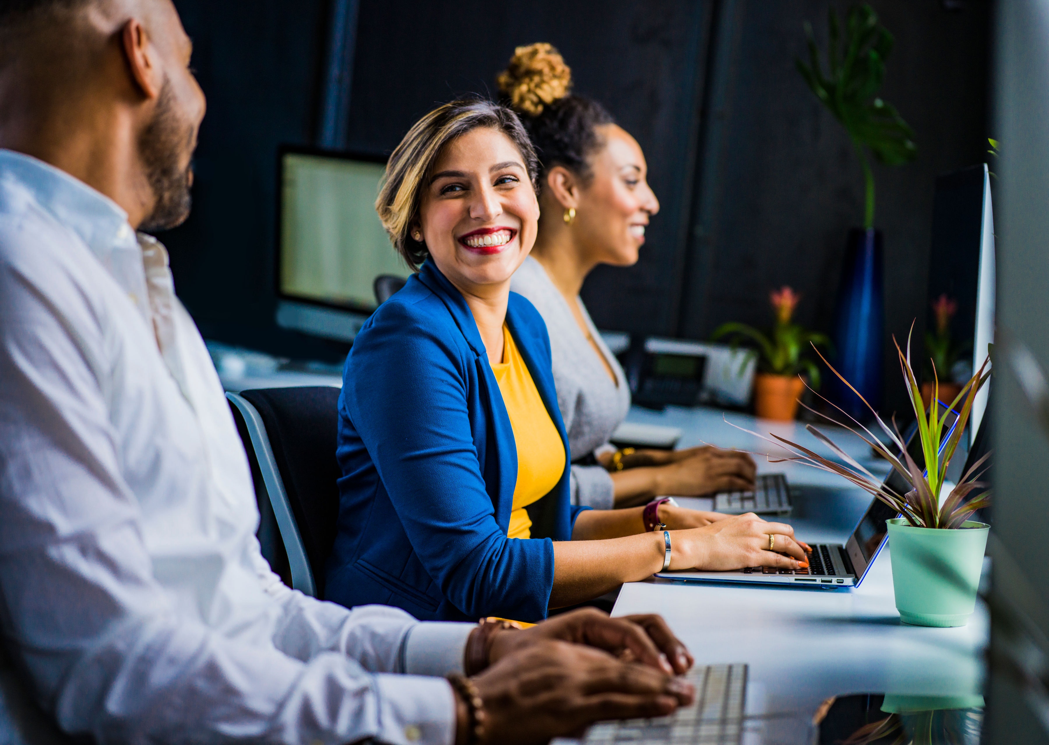3 employees smiling