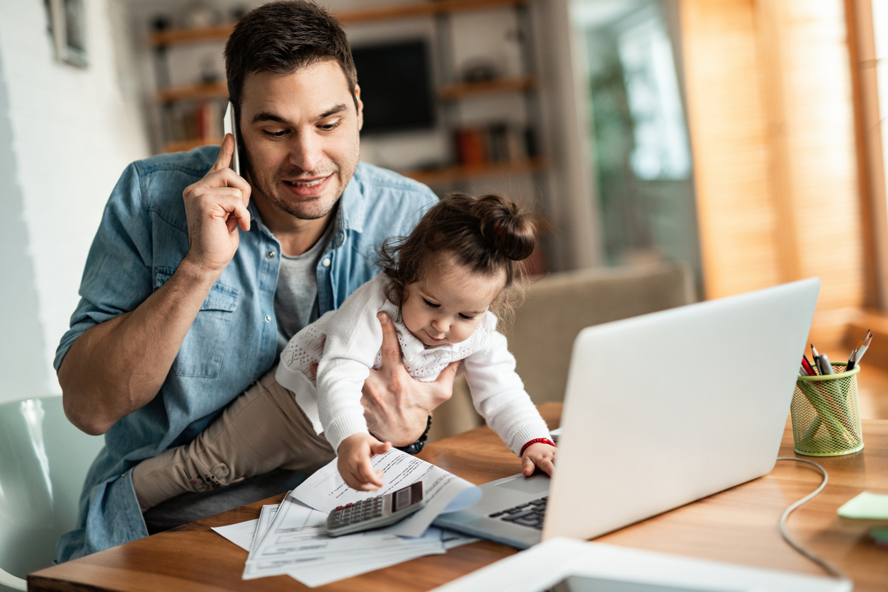 dad with baby working at home
