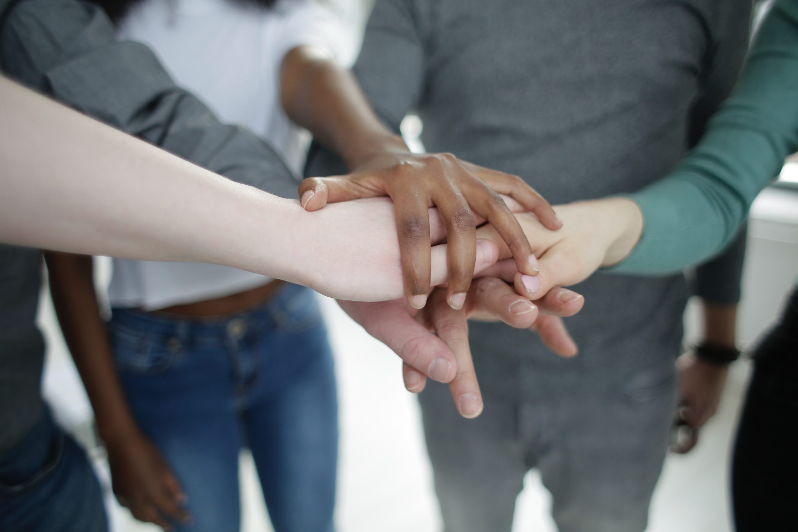 employees sticking hands in the middle