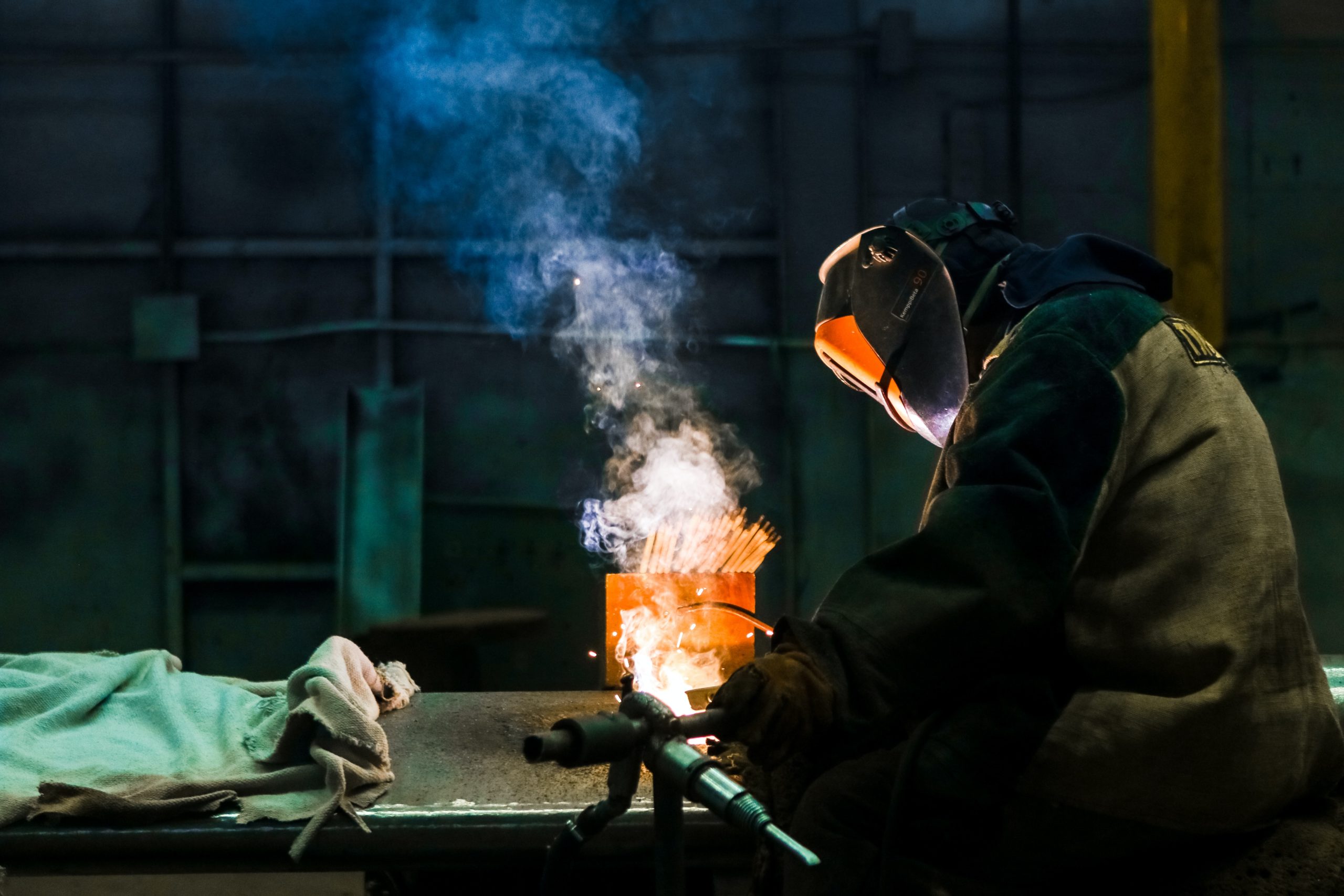 man performing dangerous job welding machine