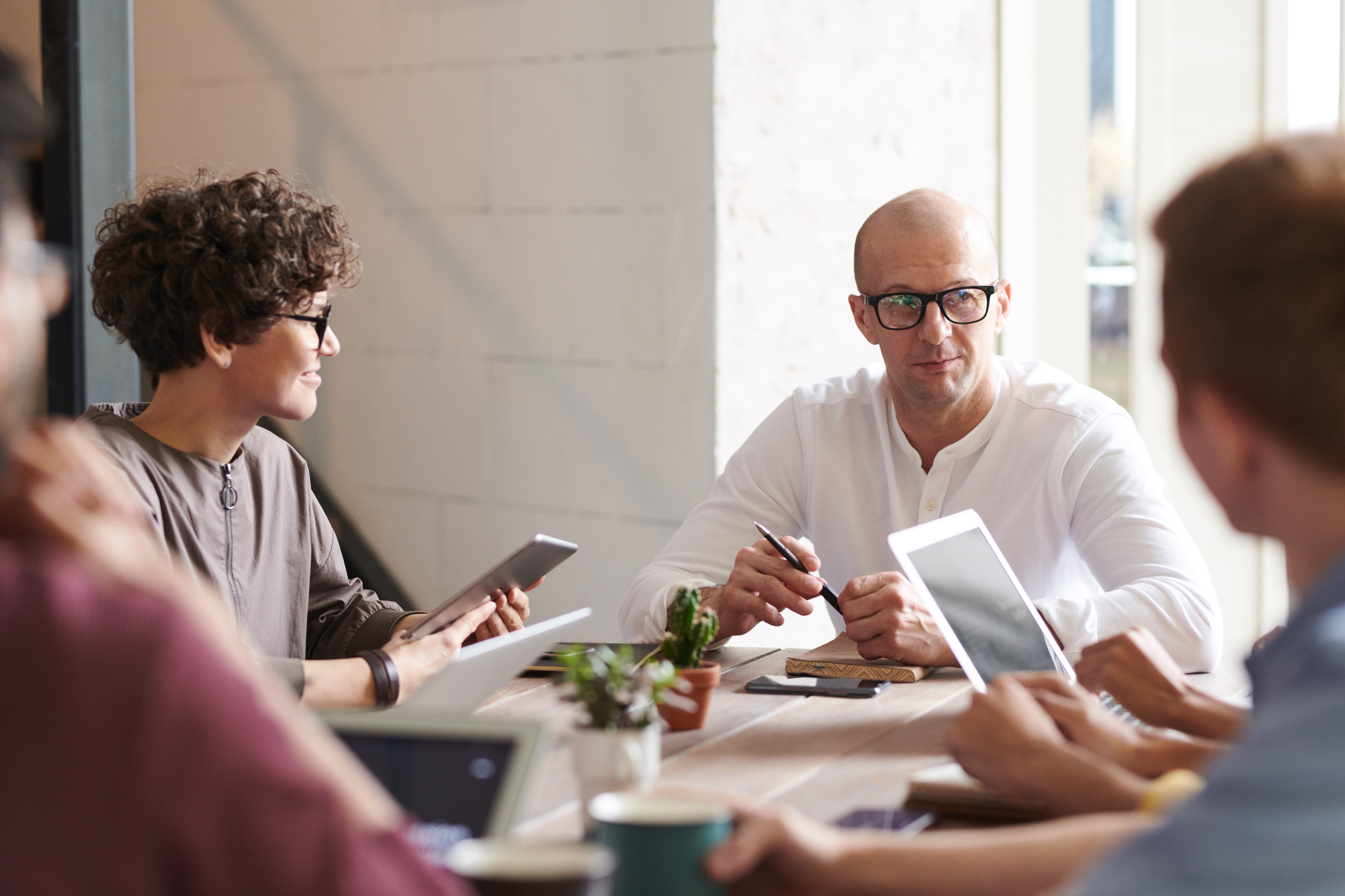older man sitting with business team